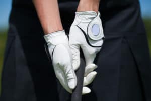 Golf player gloves hold the iron or putter