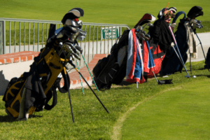 several golf bags on a putting green