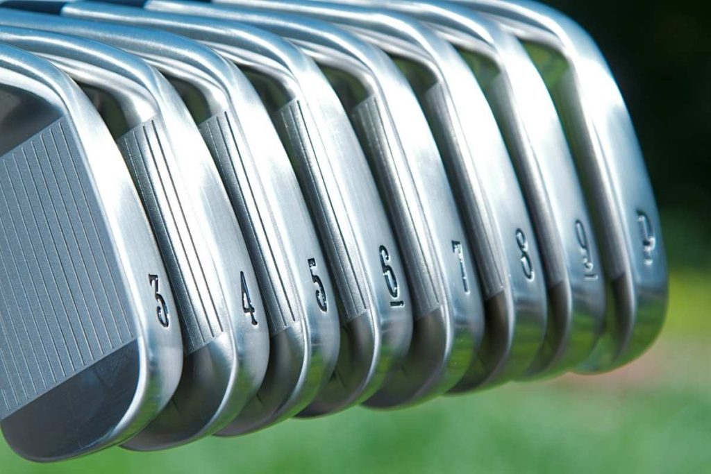 collection of golf irons lined up