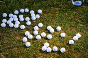 golf balls laying on the grass