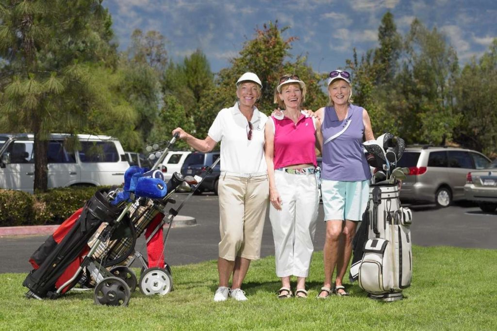 women golfers with their golf bags