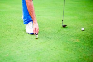 golfer repairing divot