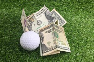 dollar bills and a golf ball