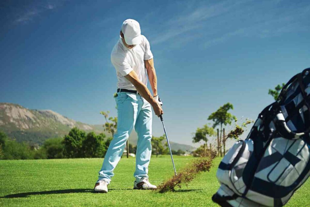 golf swing making impact with divot